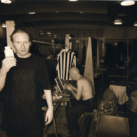 Sepia backstage photograph featuring, among others, Charles Kelly (back) getting ready for a performance of Tailors Requiem by Pan Pan Theatre Company