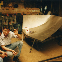 Colour photograph of two men in the workshop where the venue building for Pan Pan Theatre Company's CITY was being constructed.