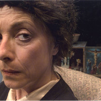 Colour close-up photograph of Jasmina Daniel of Scarlet Theatre in the Chair Women, co-produced by Pan Pan Theatre Company
