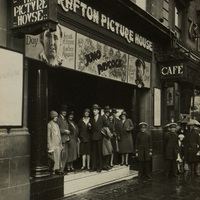 Black and white photograph of a Arthur Shields, Sara Allgood and a number of other Abbey players outside The Grafton Picture House.