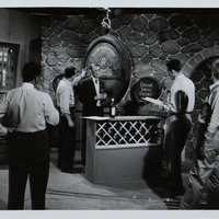 Black and white photograph of Arthur Shields and a number of crew members on the set of an Italian Swiss Colony wine television commercial.
