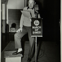 Black and white photograph of Barry Fitzgerald in front of a microphone.