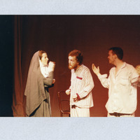 Colour photograph on grey cardboard of three actors in The Man With Two Kisses by Pan Pan Theatre Company